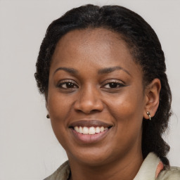 Joyful black young-adult female with medium  brown hair and brown eyes