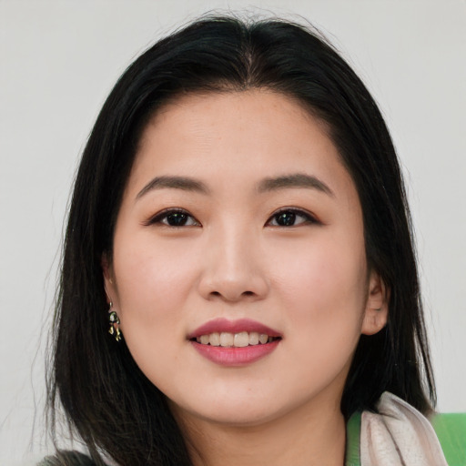 Joyful asian young-adult female with long  brown hair and brown eyes