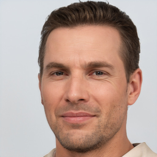 Joyful white adult male with short  brown hair and brown eyes