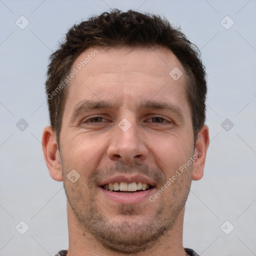 Joyful white adult male with short  brown hair and brown eyes