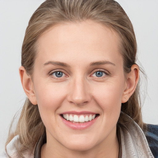 Joyful white young-adult female with medium  brown hair and blue eyes