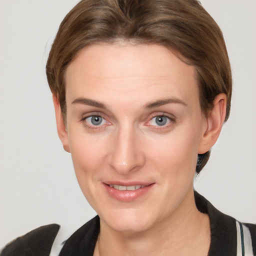 Joyful white young-adult female with short  brown hair and grey eyes