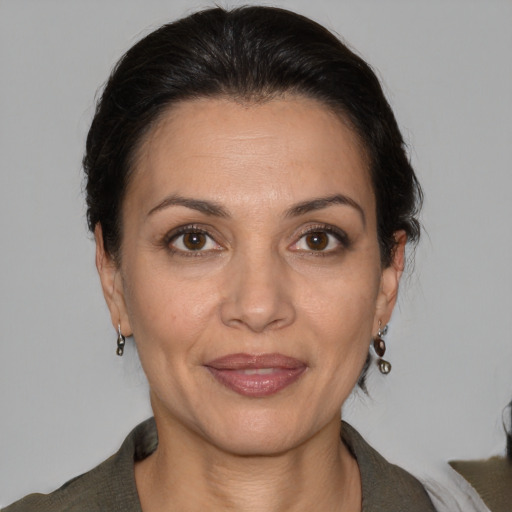 Joyful white adult female with medium  brown hair and brown eyes