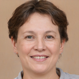 Joyful white adult female with short  brown hair and brown eyes