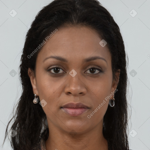 Joyful black adult female with long  brown hair and brown eyes