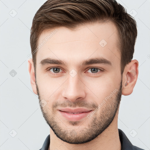 Joyful white young-adult male with short  brown hair and brown eyes