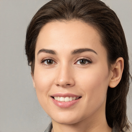 Joyful white young-adult female with medium  brown hair and brown eyes