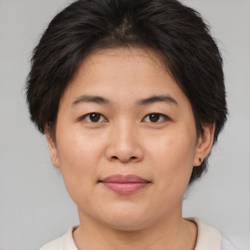Joyful asian young-adult female with short  brown hair and brown eyes