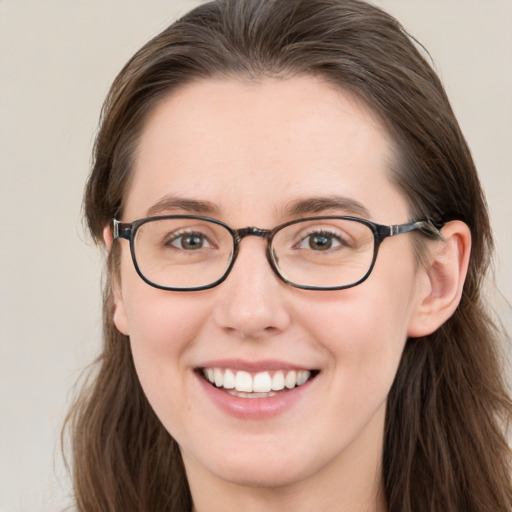 Joyful white young-adult female with long  brown hair and brown eyes