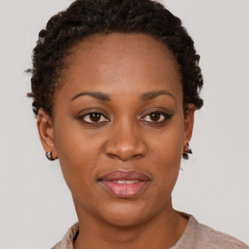 Joyful black young-adult female with short  brown hair and brown eyes