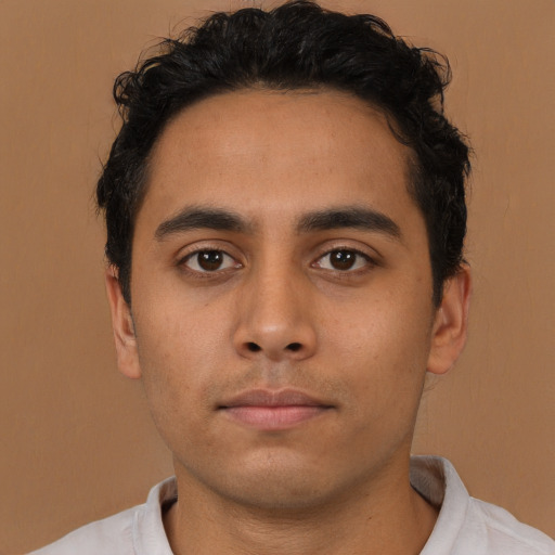 Neutral latino young-adult male with short  brown hair and brown eyes