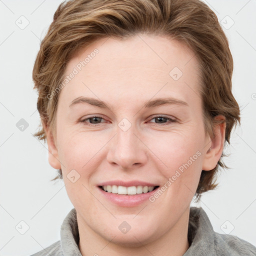 Joyful white young-adult female with medium  brown hair and grey eyes