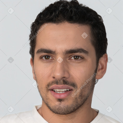 Joyful white young-adult male with short  black hair and brown eyes