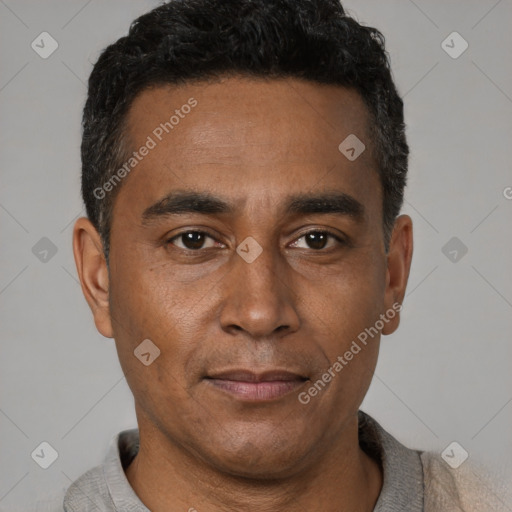 Joyful latino young-adult male with short  brown hair and brown eyes