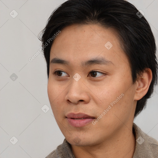 Joyful asian young-adult male with short  brown hair and brown eyes