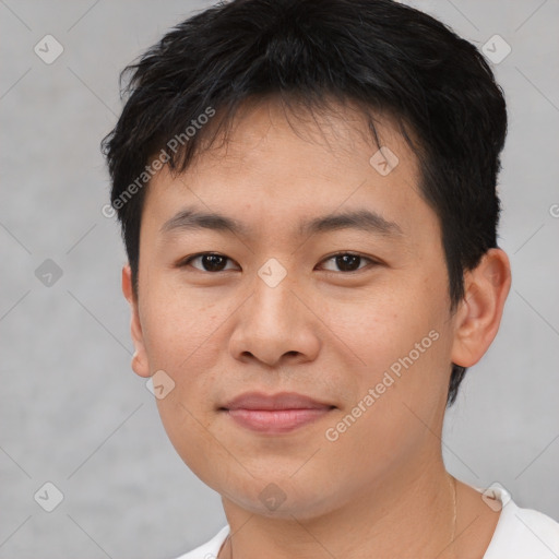 Joyful asian young-adult male with short  brown hair and brown eyes