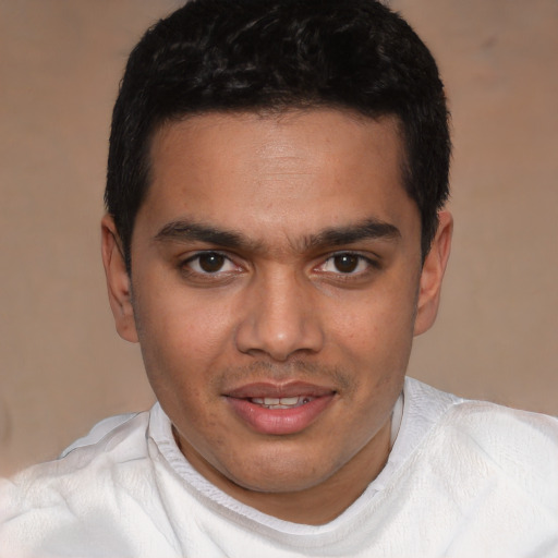 Joyful white young-adult male with short  black hair and brown eyes