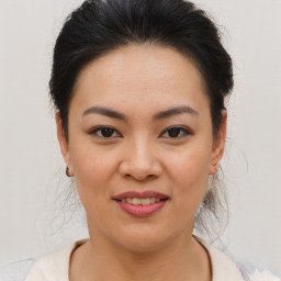 Joyful asian young-adult female with medium  brown hair and brown eyes