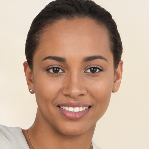 Joyful latino young-adult female with short  brown hair and brown eyes