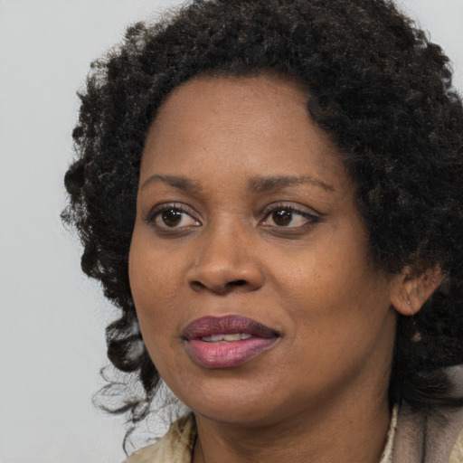 Joyful black adult female with medium  black hair and brown eyes