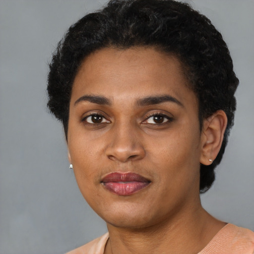 Joyful latino young-adult female with short  black hair and brown eyes