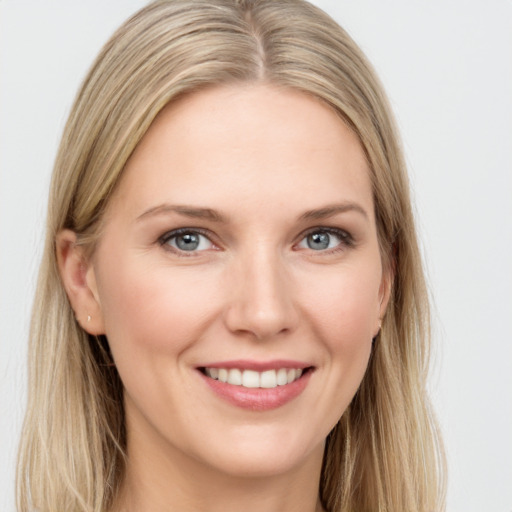 Joyful white young-adult female with long  brown hair and blue eyes