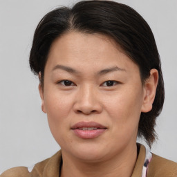 Joyful asian adult female with short  brown hair and brown eyes