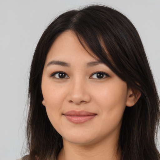 Joyful asian young-adult female with long  brown hair and brown eyes