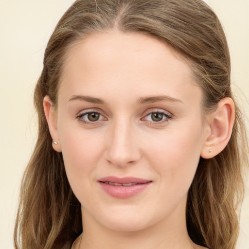 Joyful white young-adult female with long  brown hair and green eyes