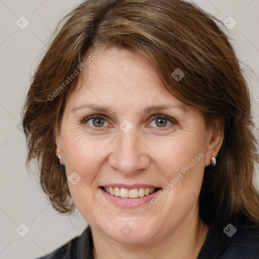 Joyful white adult female with medium  brown hair and grey eyes