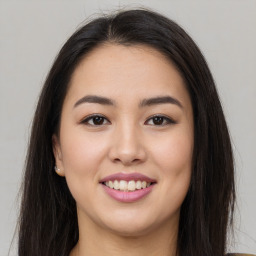 Joyful asian young-adult female with long  brown hair and brown eyes