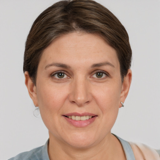 Joyful white adult female with short  brown hair and grey eyes