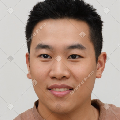 Joyful asian young-adult male with short  brown hair and brown eyes