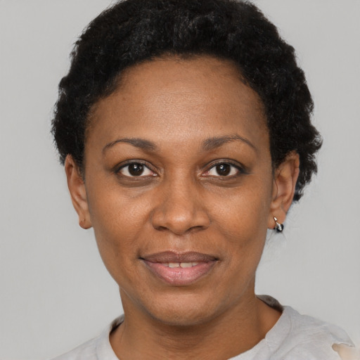 Joyful latino adult female with short  black hair and brown eyes