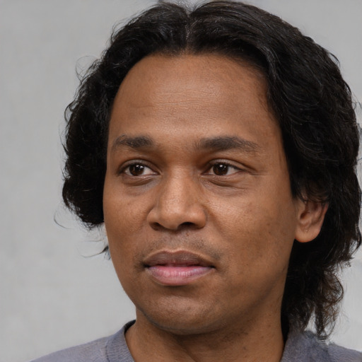 Joyful asian adult male with medium  brown hair and brown eyes