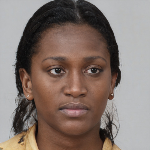 Neutral black young-adult female with medium  brown hair and brown eyes