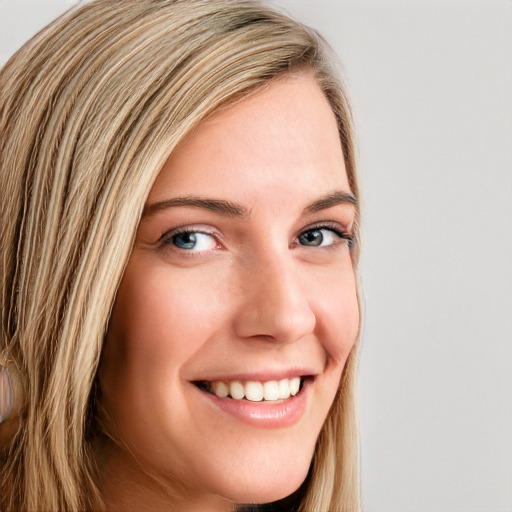 Joyful white young-adult female with long  brown hair and blue eyes