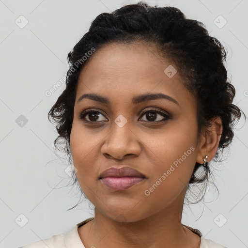 Joyful black young-adult female with long  brown hair and brown eyes