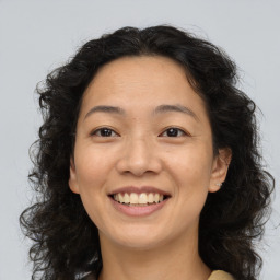 Joyful white adult female with long  brown hair and brown eyes