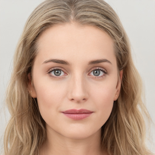 Joyful white young-adult female with long  brown hair and blue eyes