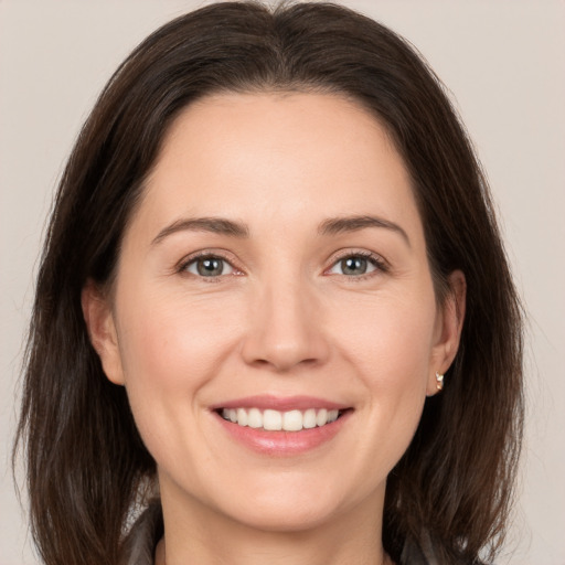 Joyful white young-adult female with medium  brown hair and brown eyes