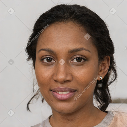 Joyful black young-adult female with medium  brown hair and brown eyes