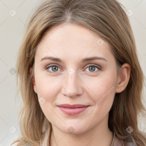 Joyful white young-adult female with medium  brown hair and blue eyes