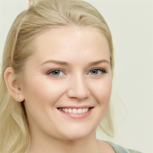 Joyful white young-adult female with long  blond hair and blue eyes