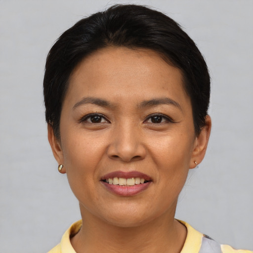 Joyful asian young-adult female with short  brown hair and brown eyes