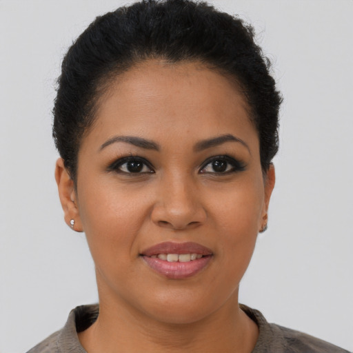 Joyful latino young-adult female with short  brown hair and brown eyes