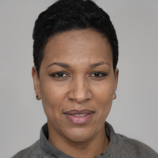 Joyful black adult female with short  black hair and brown eyes