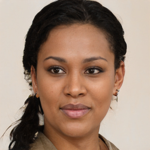 Joyful black young-adult female with long  black hair and brown eyes