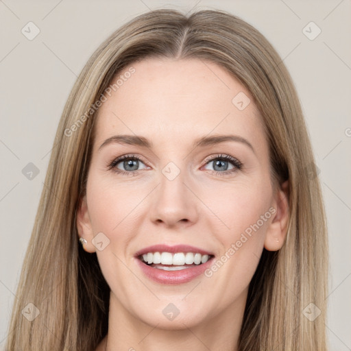 Joyful white young-adult female with long  brown hair and grey eyes