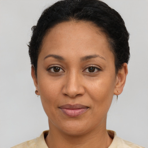 Joyful latino young-adult female with short  brown hair and brown eyes